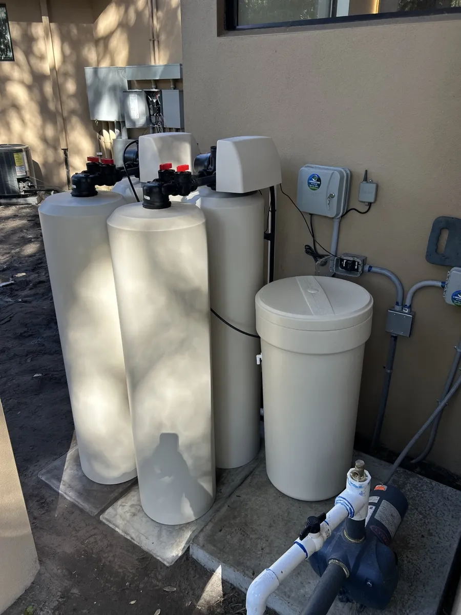Multi-tank well water system with pump and brine tank installed outdoors