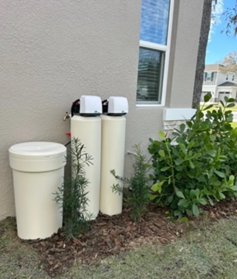 Genuine Florida Water Pros twin-tank installation beside a landscaped Florida home